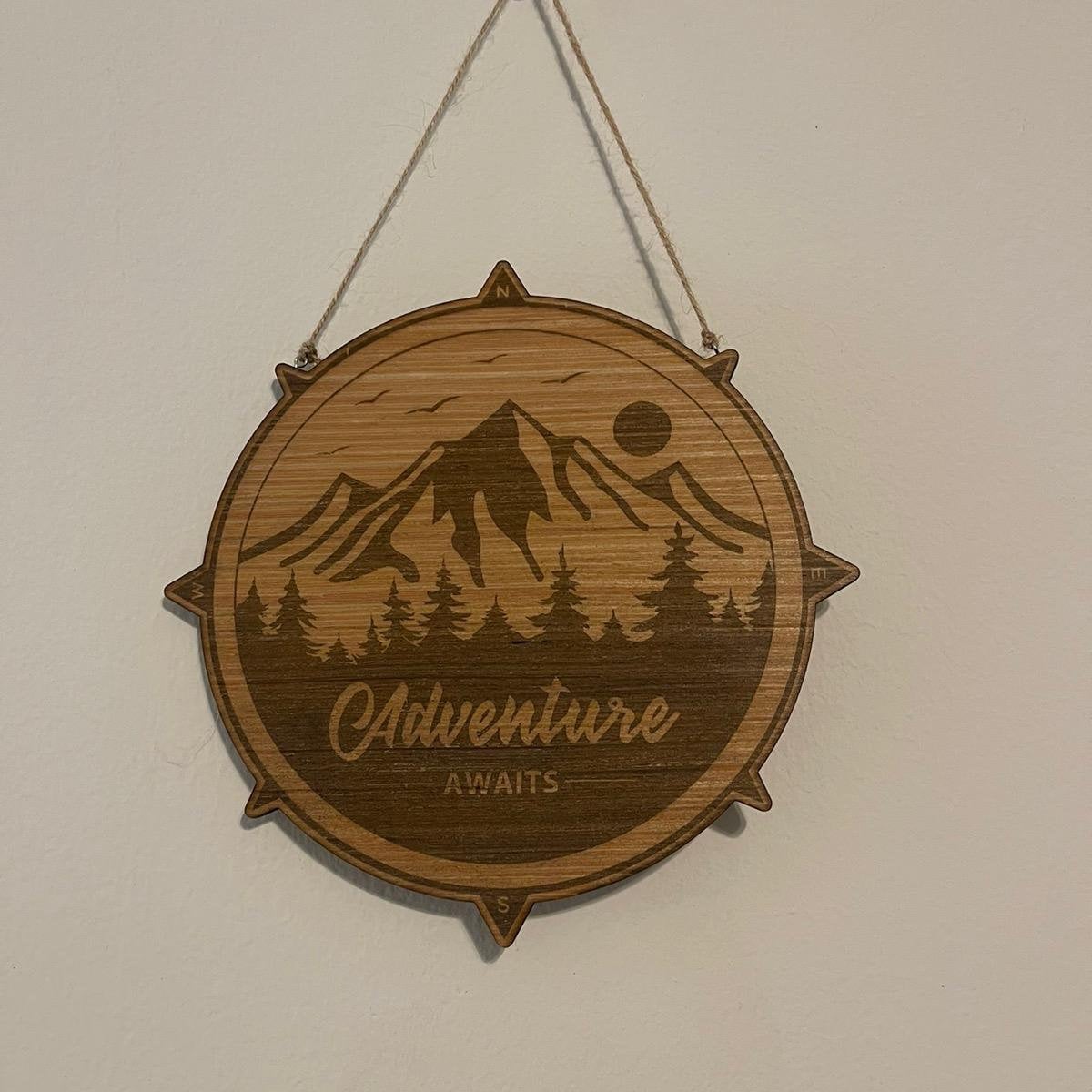 Adventure awaits compass outdoor terrain sign