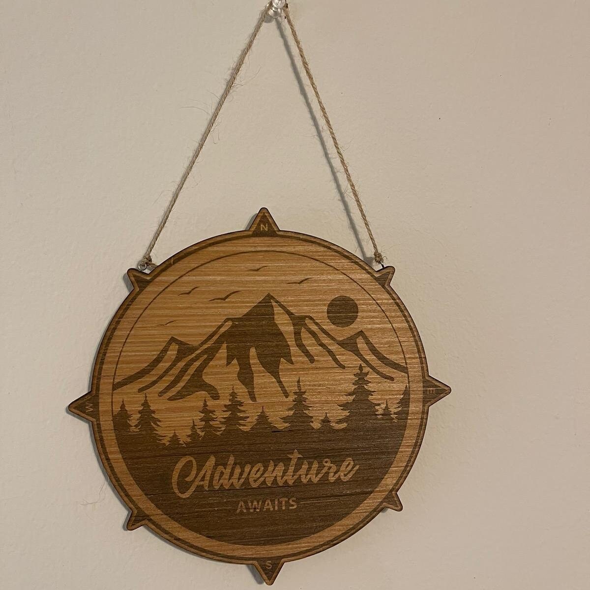 Adventure awaits outdoors mountain tree compass sign